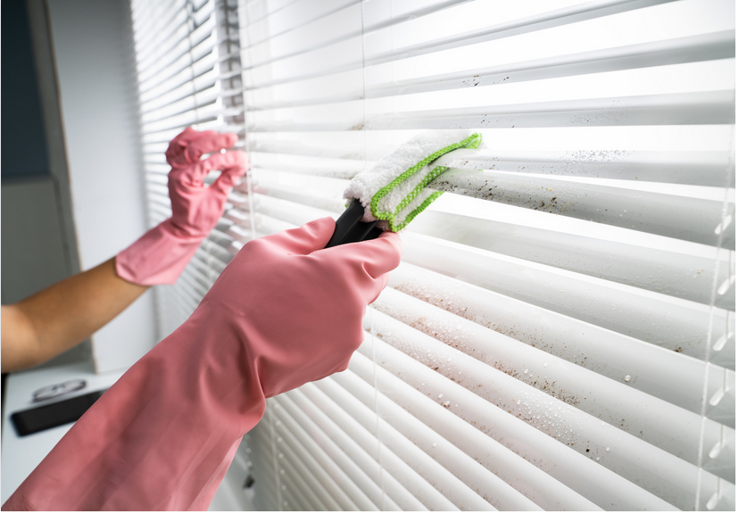 Close the blinds and use a microfiber cloth or a duster to remove loose dust